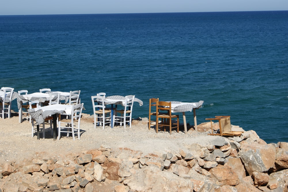 a bunch of chairs that are sitting on a beach