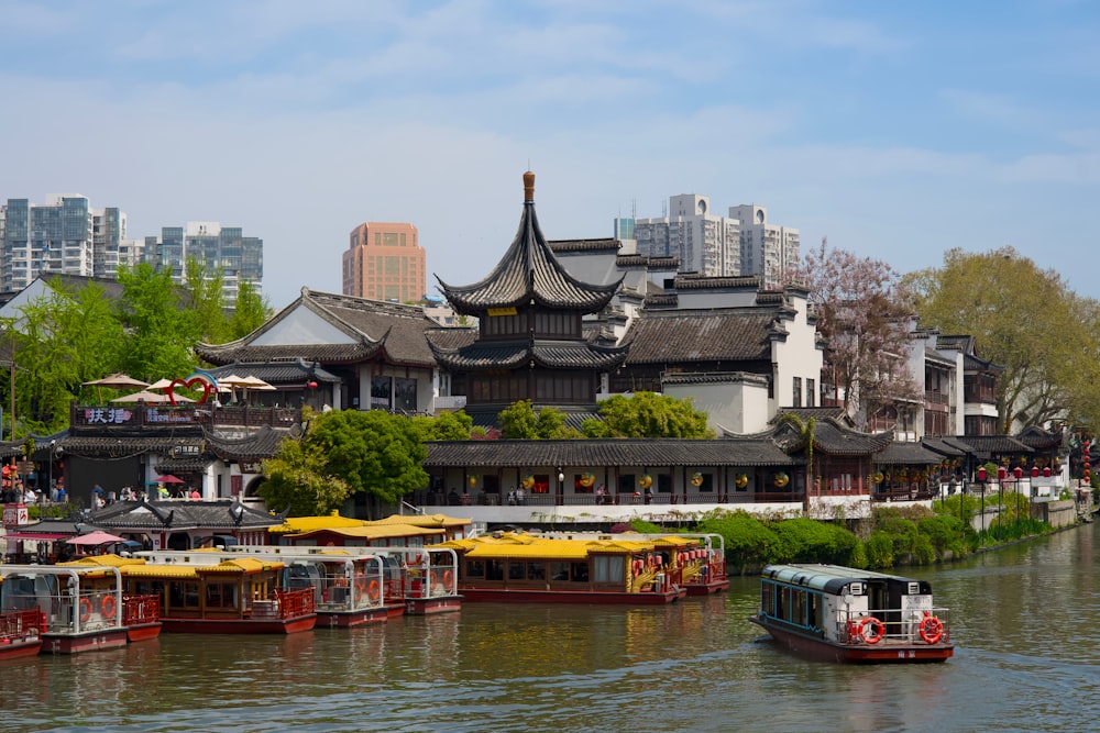 a group of boats floating on top of a river