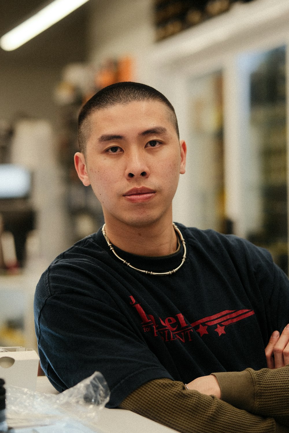 a man sitting at a table with his arms crossed