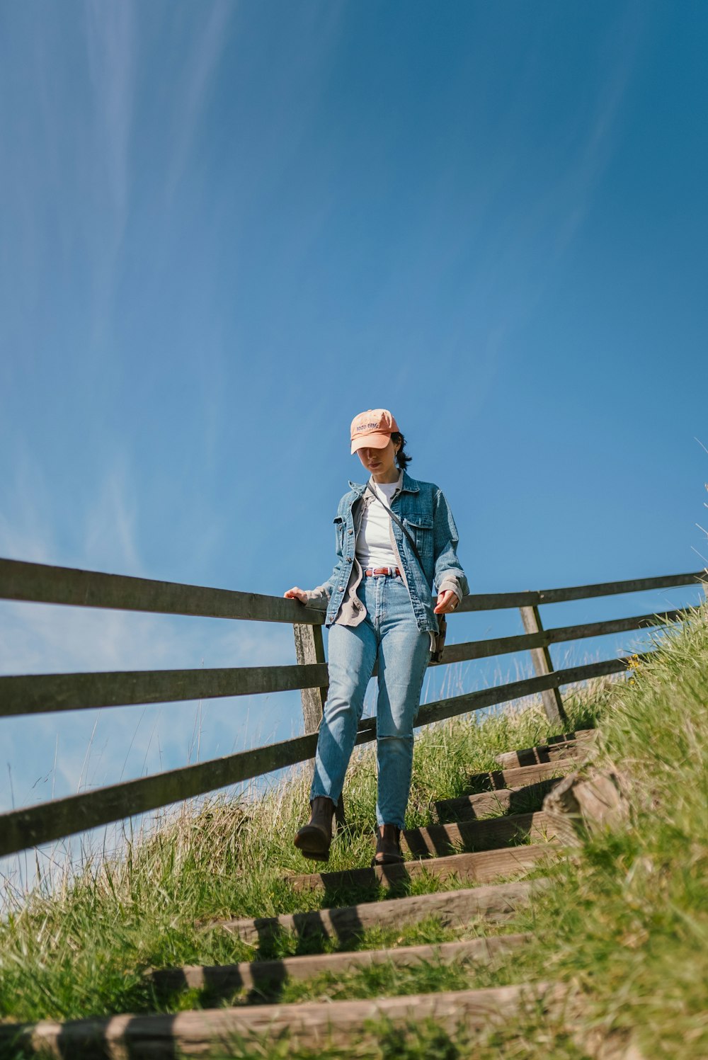 a woman standing on top of a set of stairs