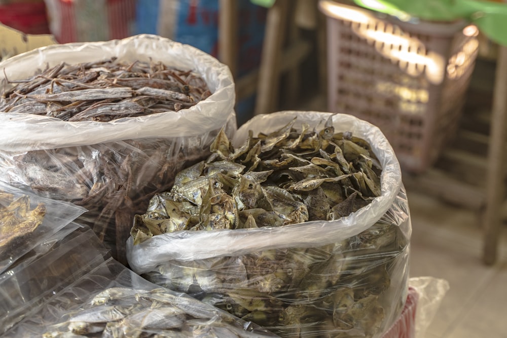 three bags of dried herbs sitting on top of a table