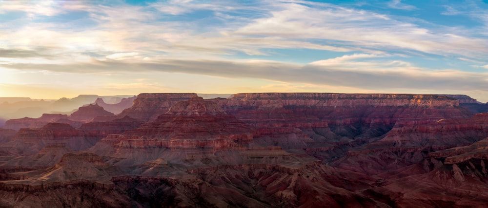 the sun is setting at the grand canyon