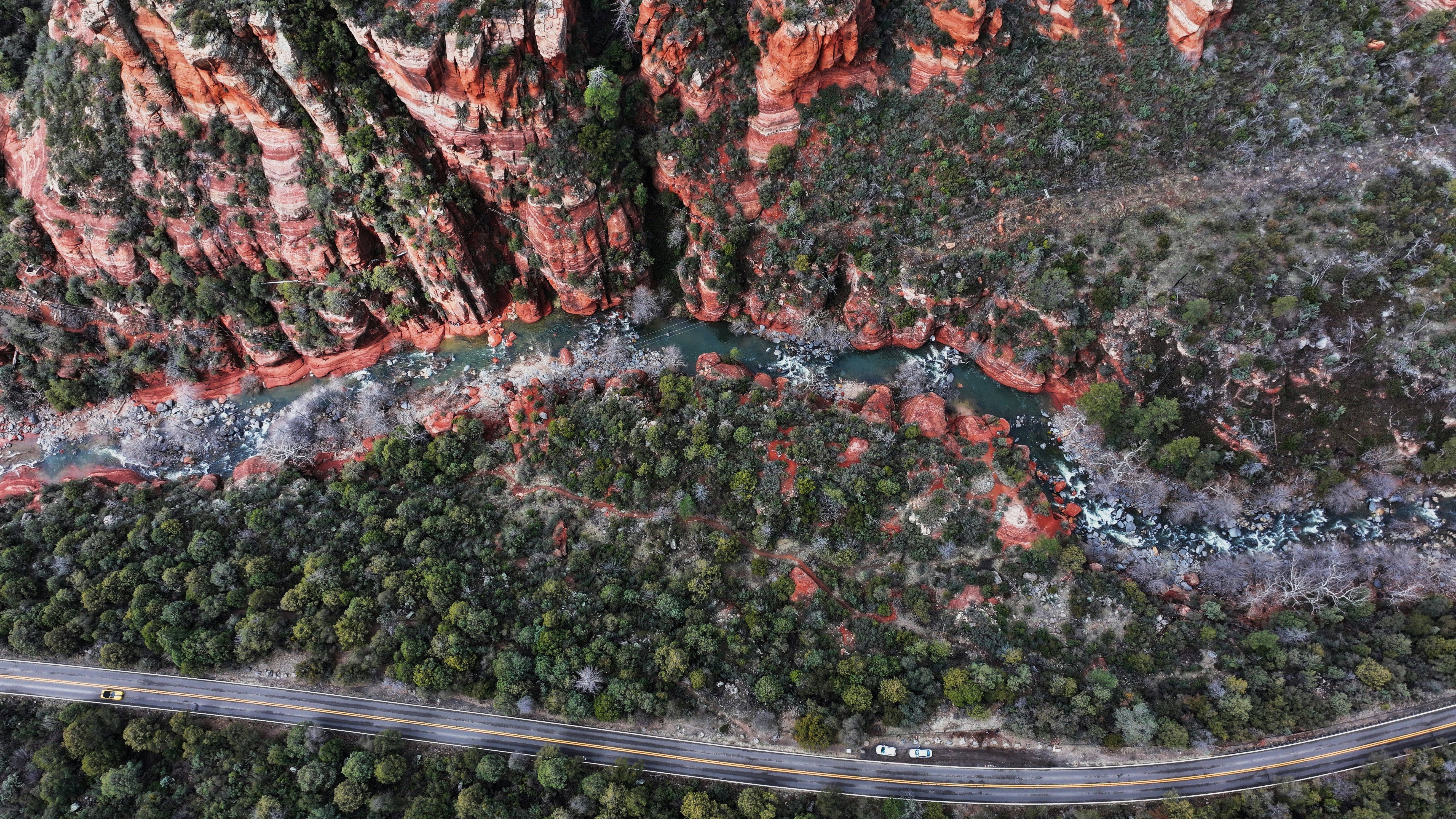 an aerial view of a winding road in the mountains