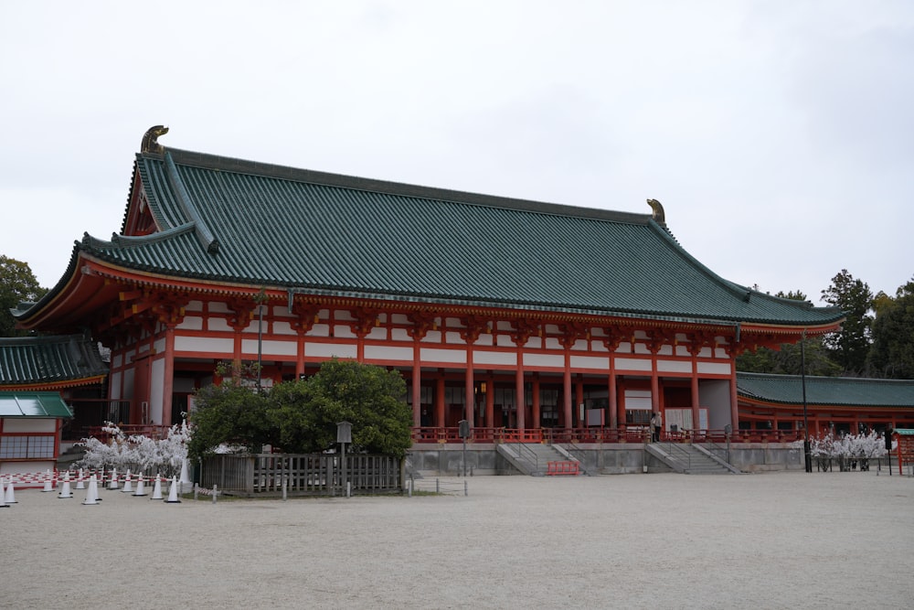 a large building with a green roof and red trim