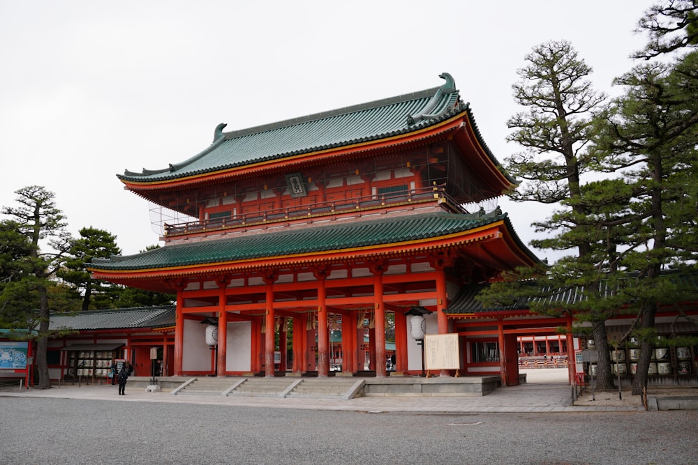 a tall red building with a green roof