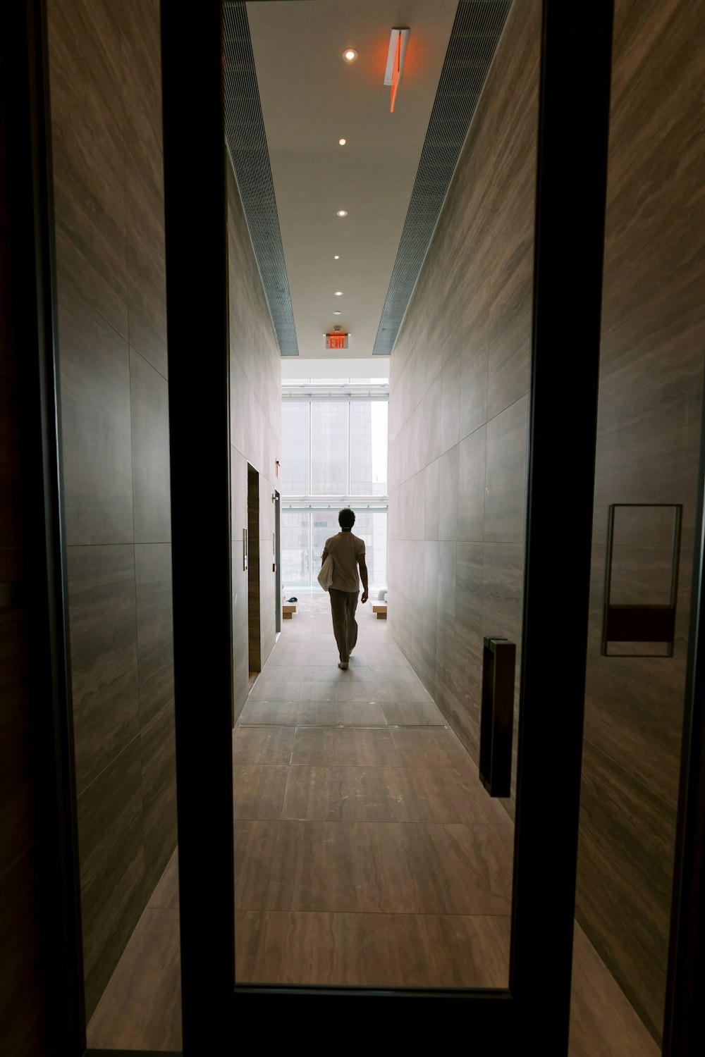 a person walking down a hallway in a building