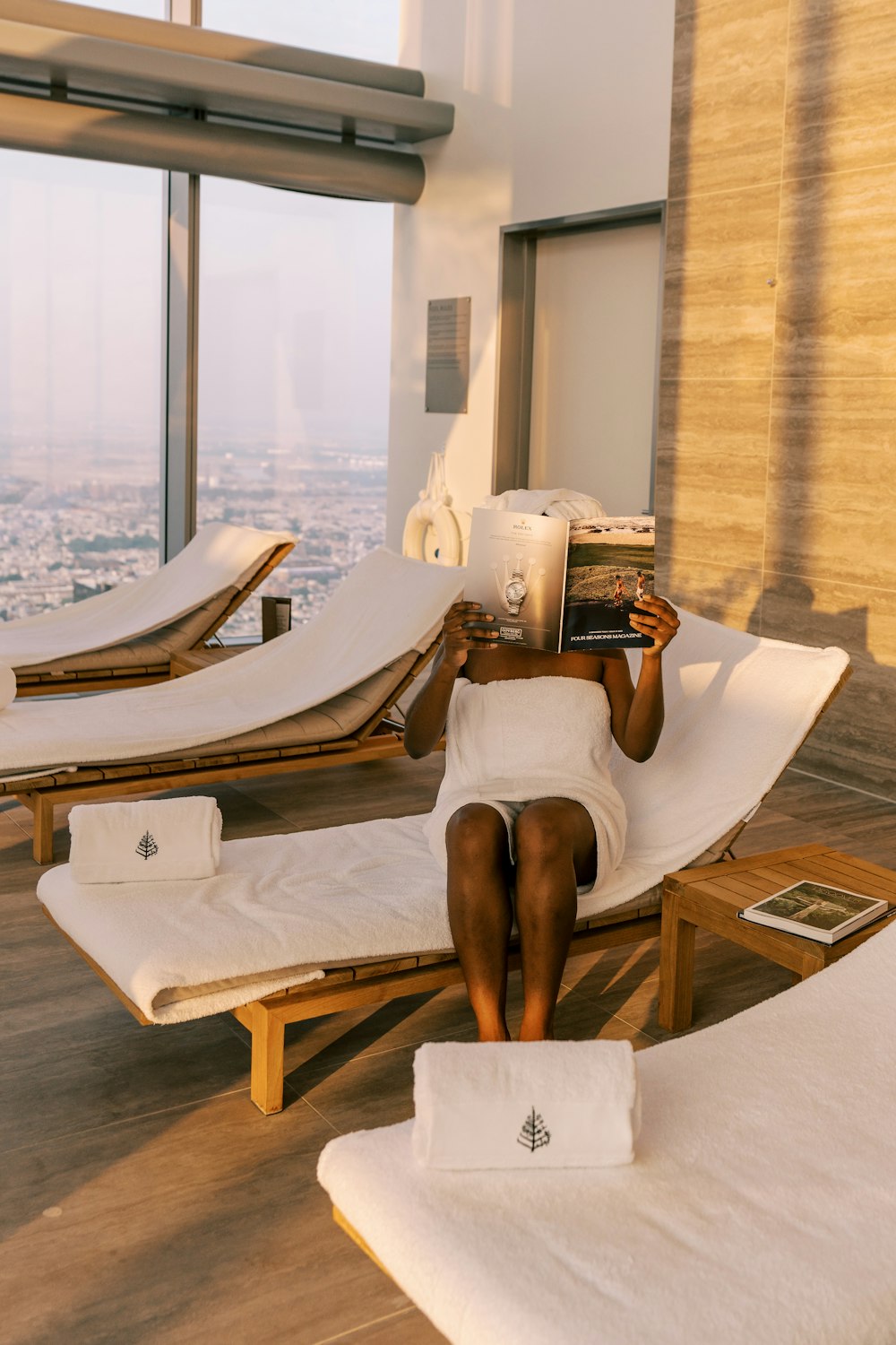 a woman laying on a chaise lounge in a hotel room