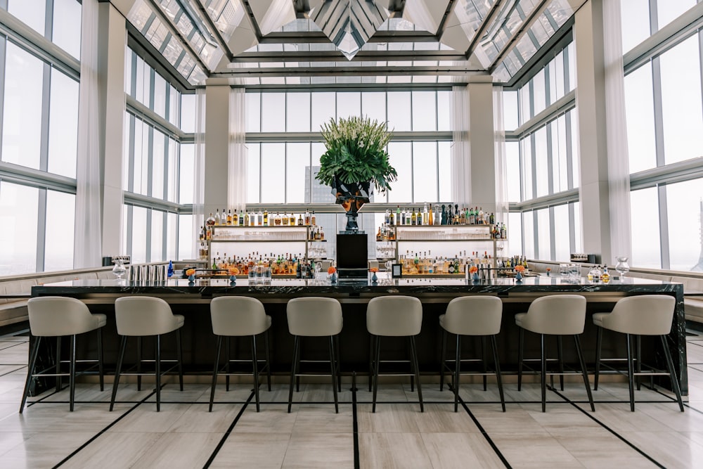 a bar with a bunch of chairs around it