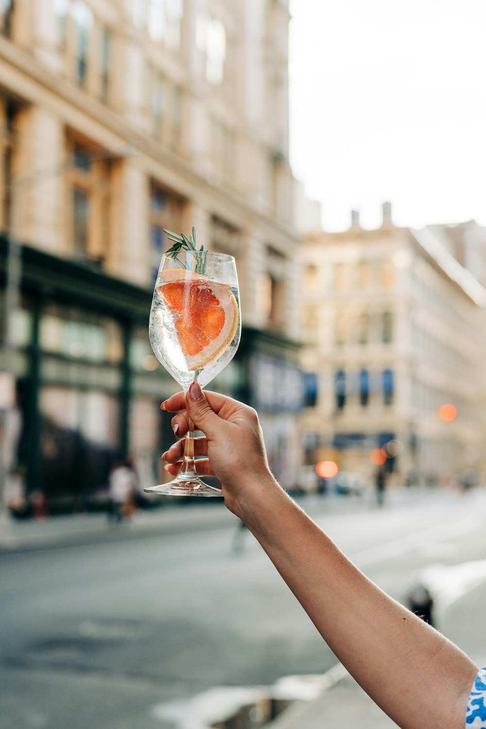 a person holding up a wine glass in the air