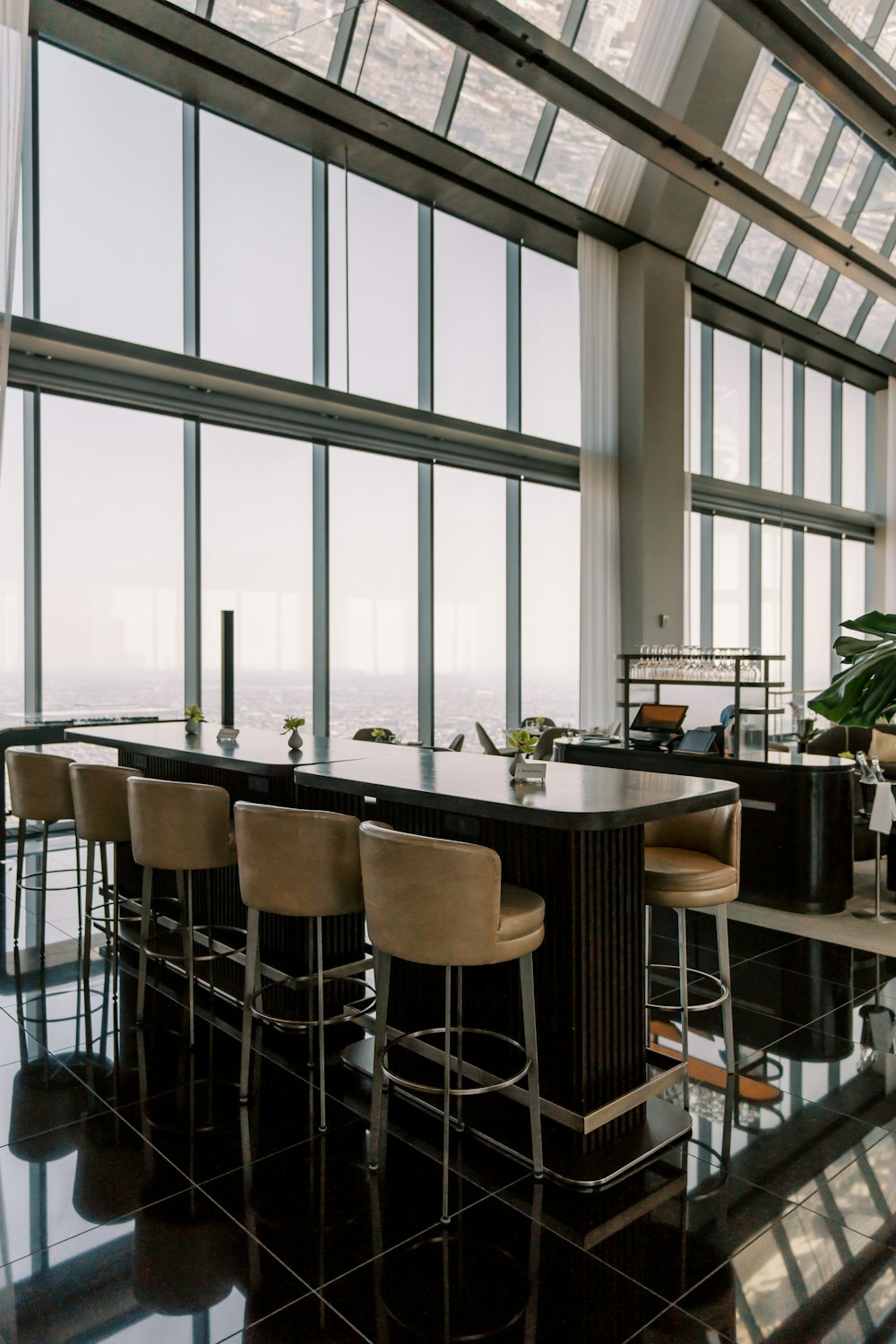 a large kitchen with a bar and lots of windows