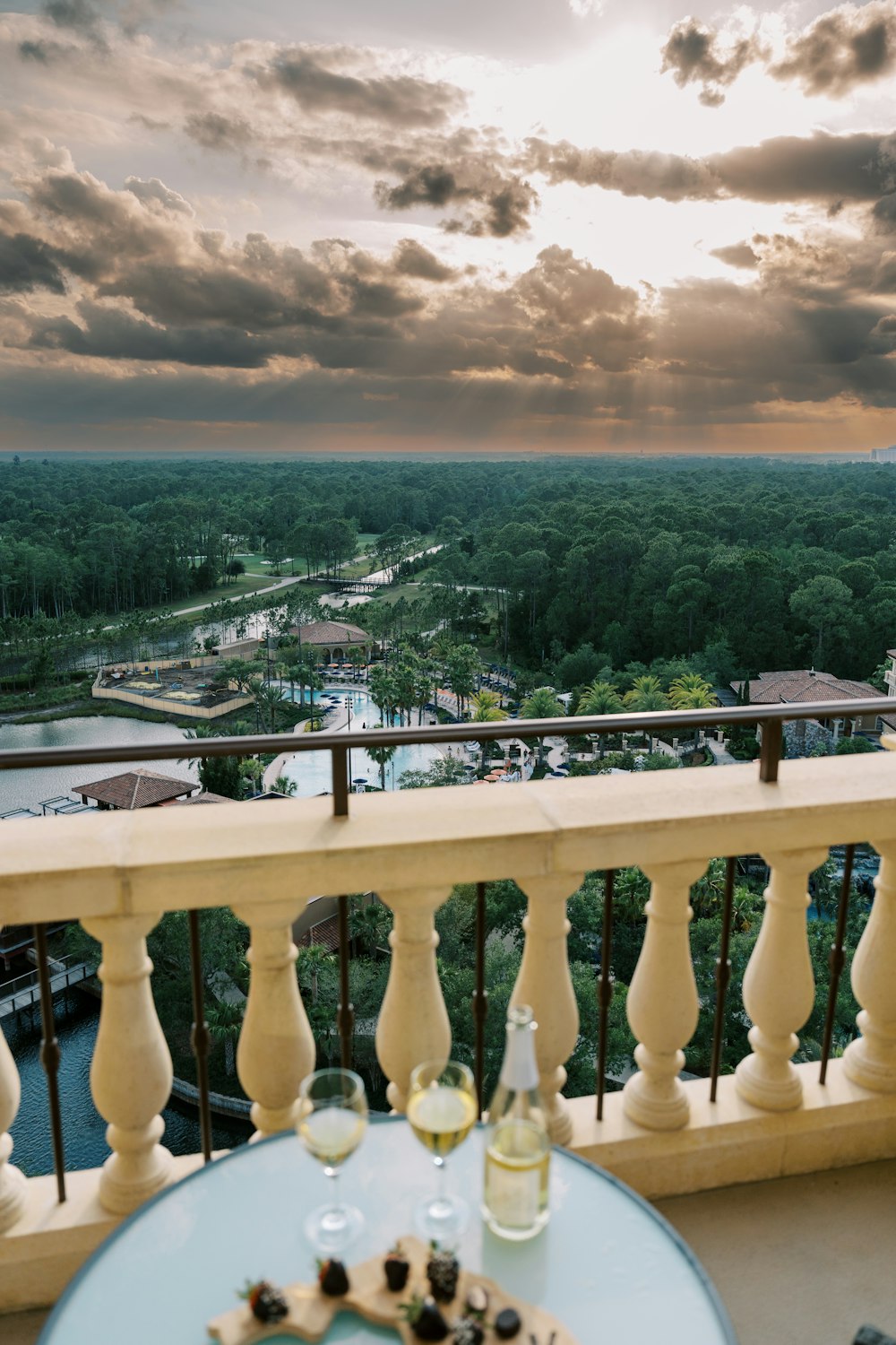 a balcony with a table and two glasses of wine