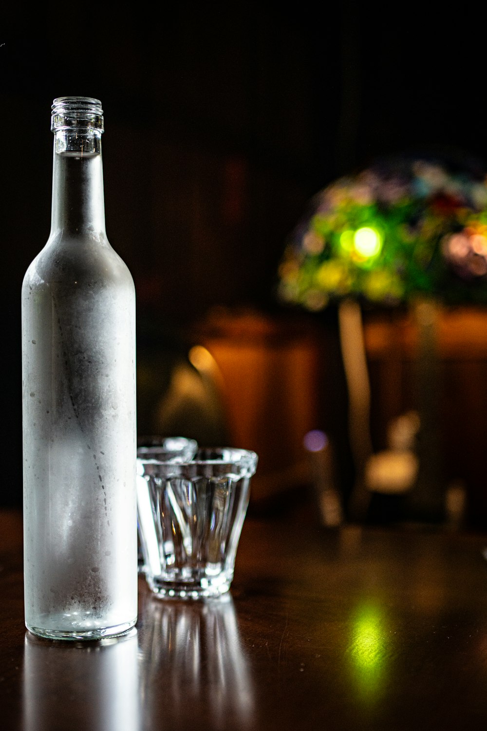 a bottle and a glass on a table