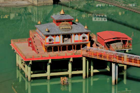 a pier with a red and yellow building on top of it