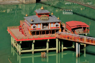 a pier with a red and yellow building on top of it