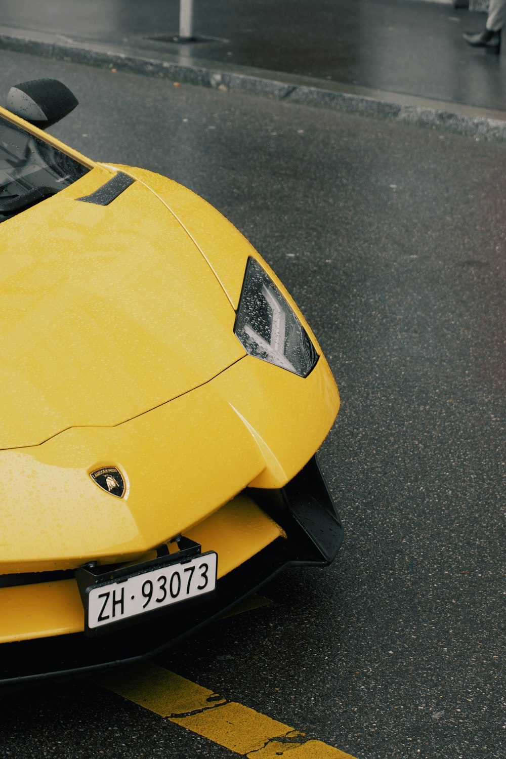 a yellow sports car parked on the side of the road