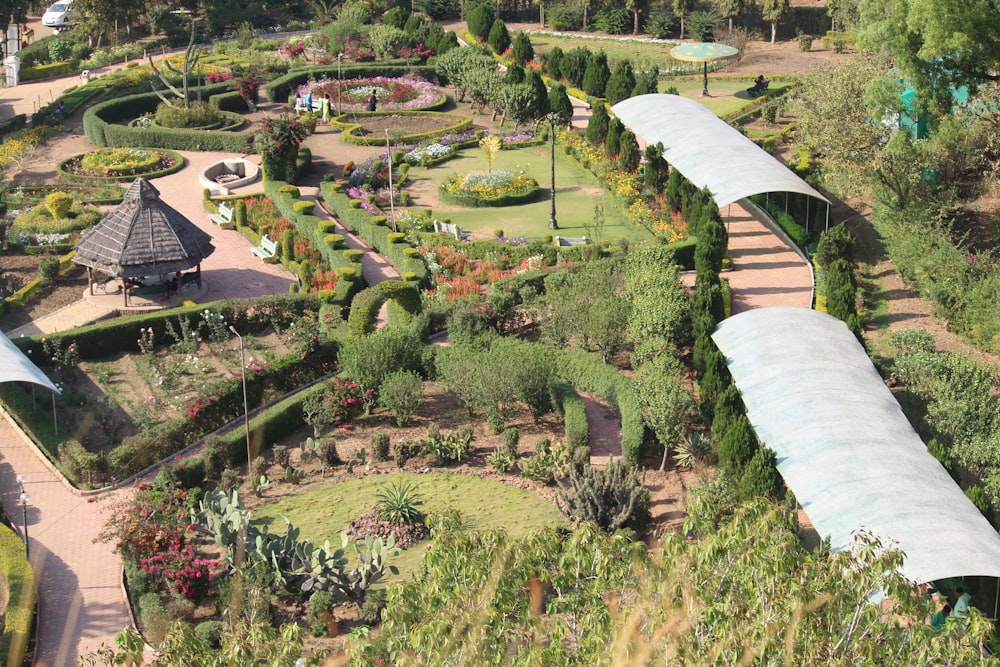 an aerial view of a garden with a train on the tracks