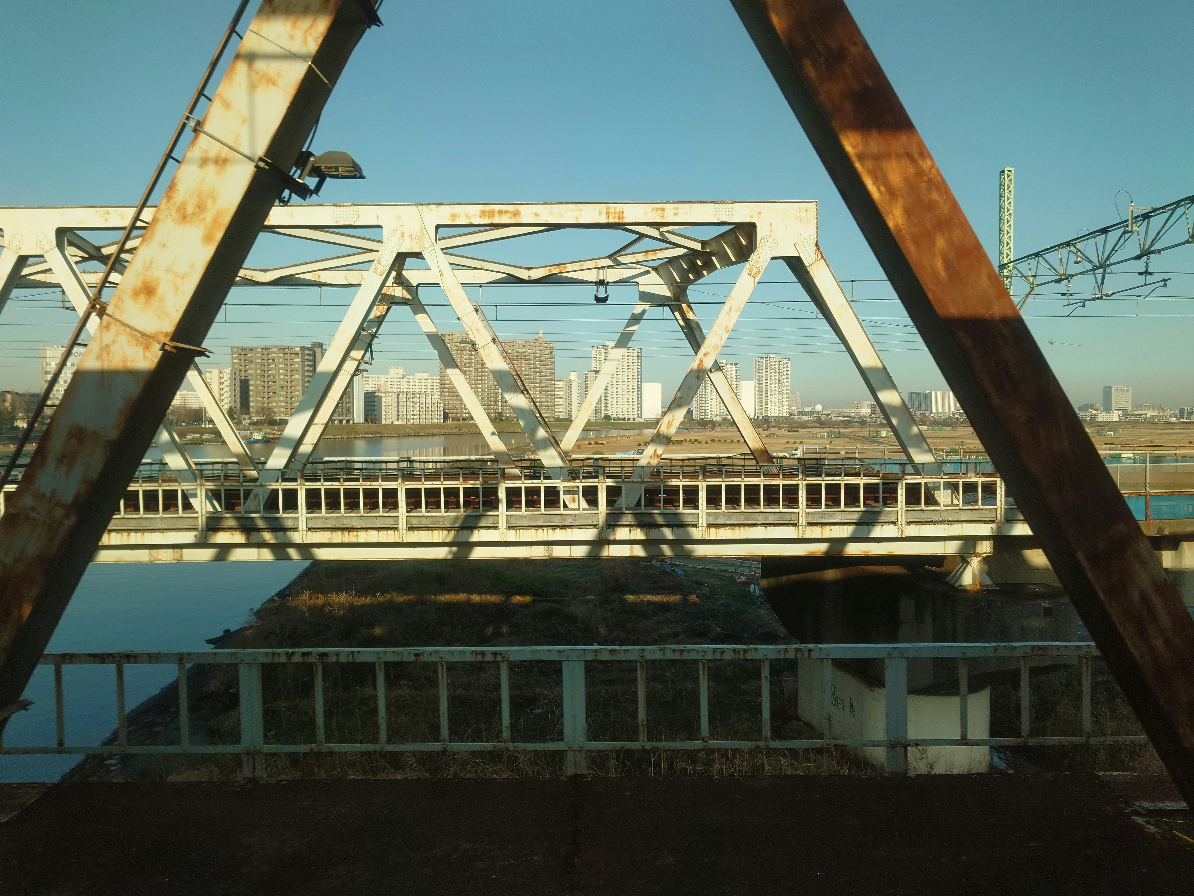 a train traveling over a bridge over a river