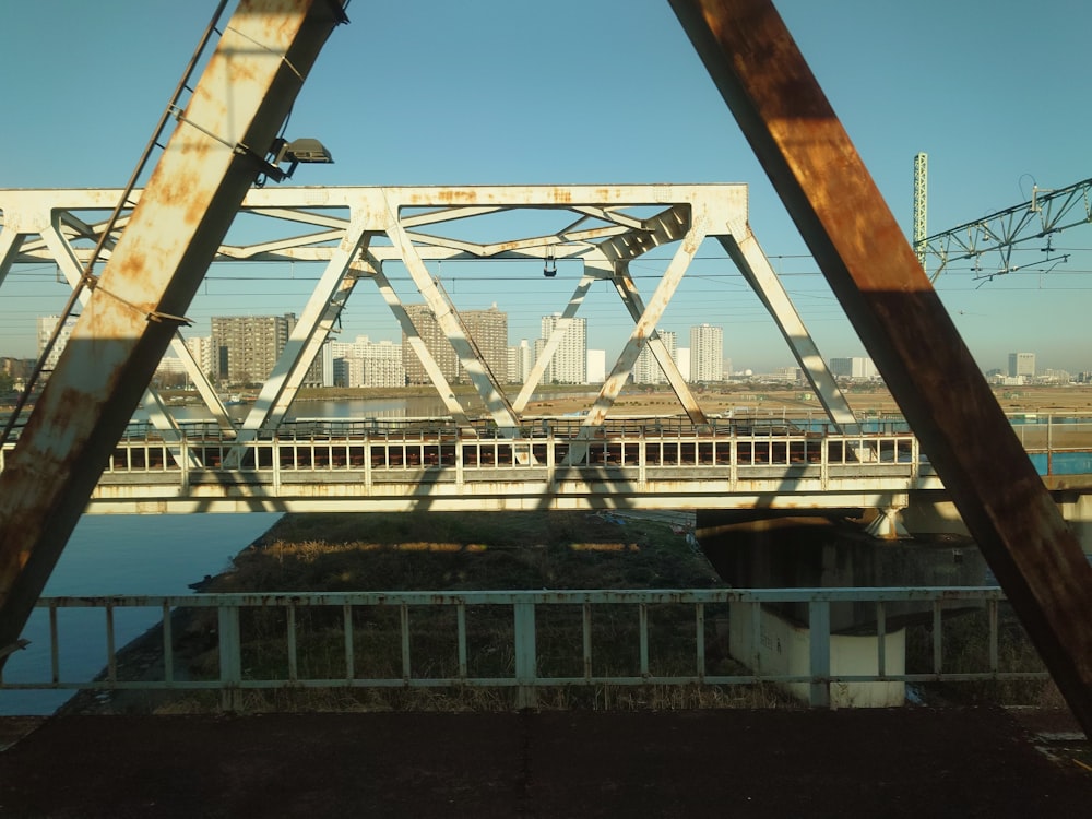 a train traveling over a bridge over a river