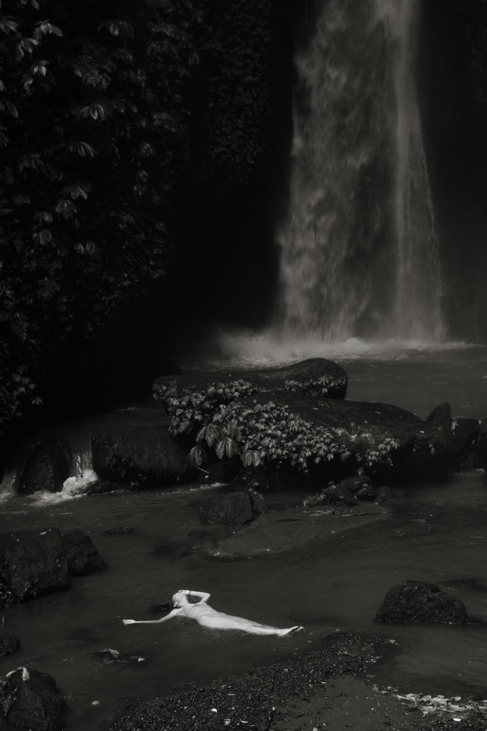 a black and white photo of a waterfall