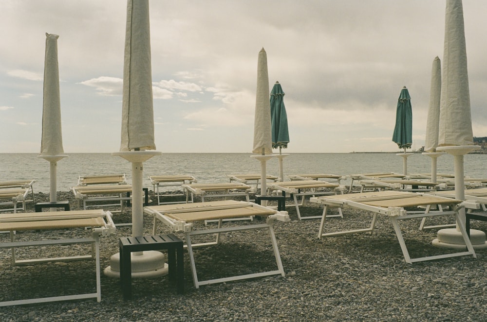 a bunch of chairs and umbrellas on a beach