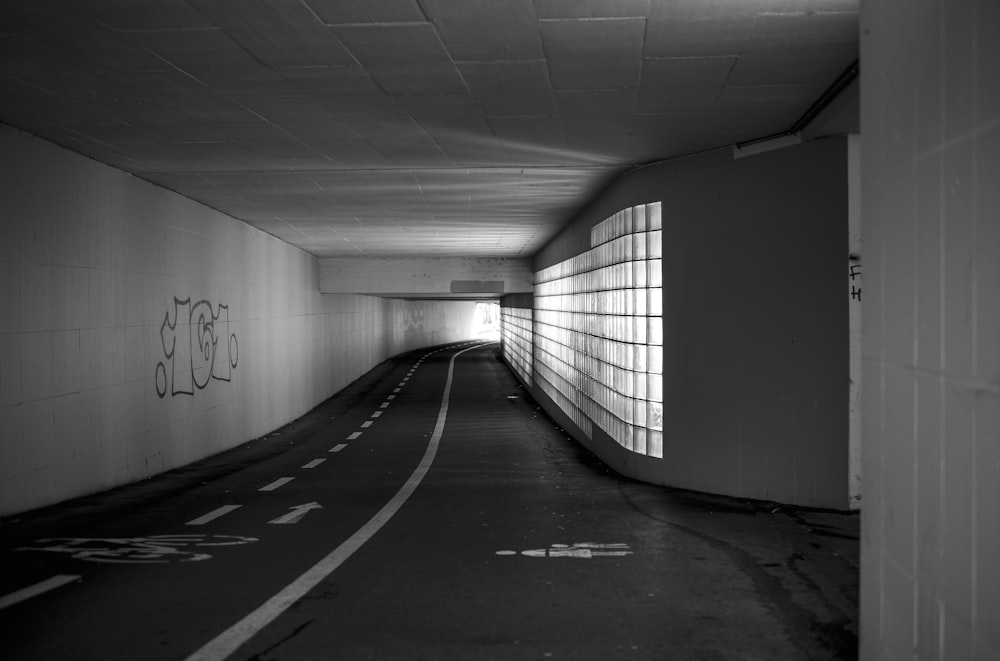 a dark tunnel with graffiti on the walls