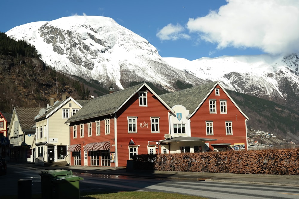 a red building with a mountain in the background