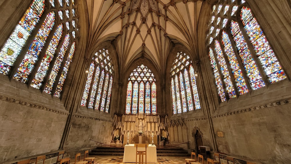 a cathedral with stained glass windows and pews