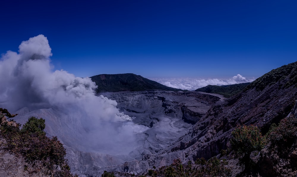 a large plume of smoke coming out of a mountain