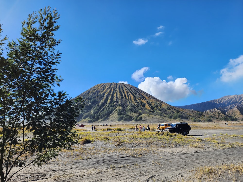 a group of people standing next to a mountain