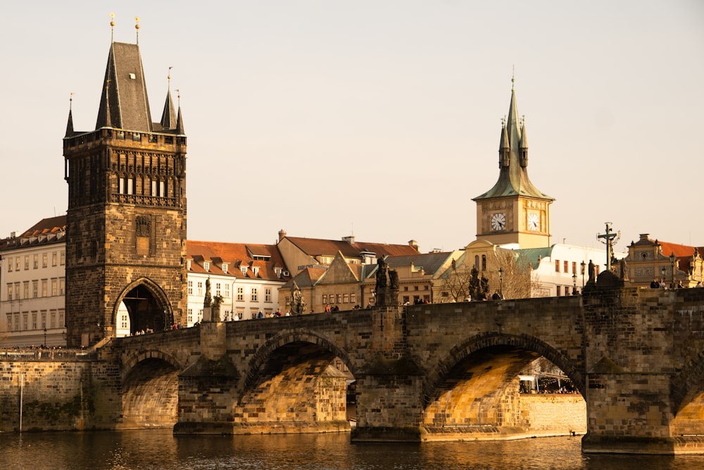 a bridge over a body of water with a castle in the background