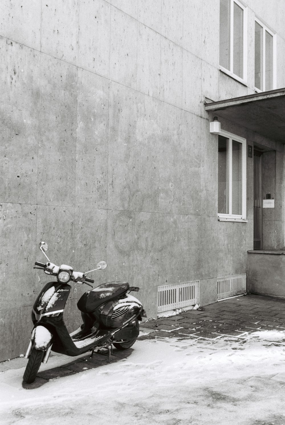 a motor scooter parked in front of a building