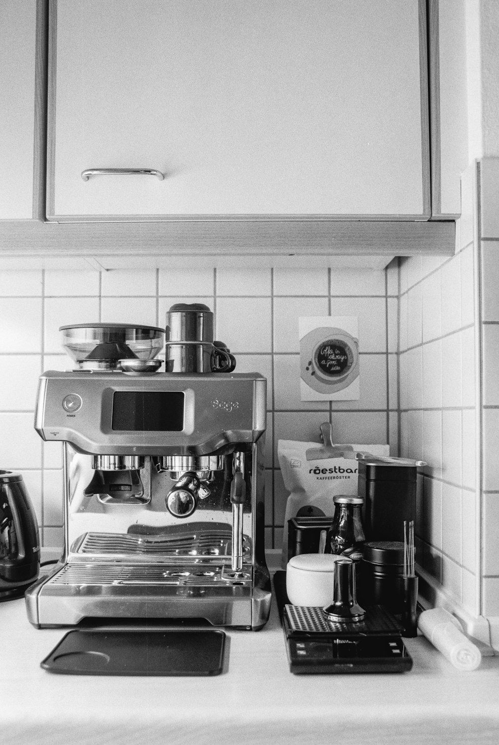 a black and white photo of a coffee maker