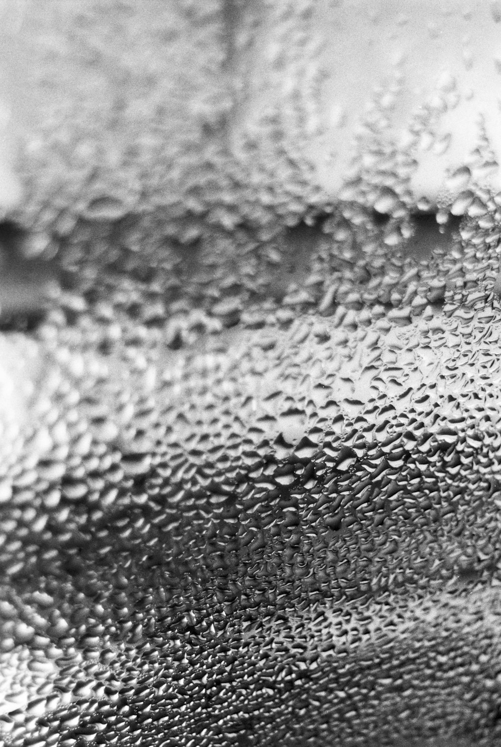 a black and white photo of water droplets