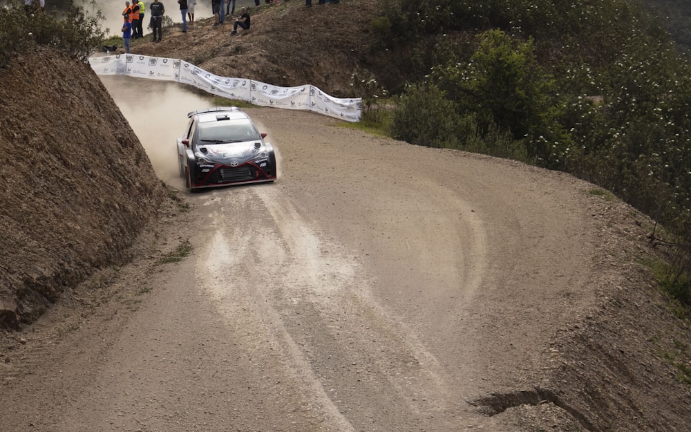 a car is driving down a dirt road