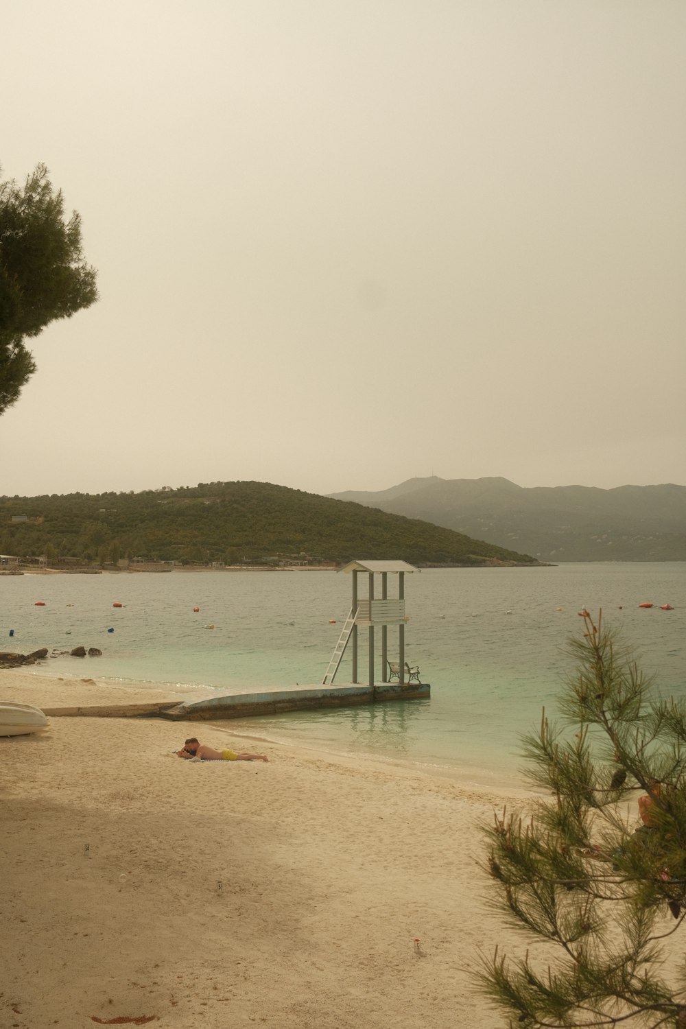 a body of water sitting next to a sandy beach