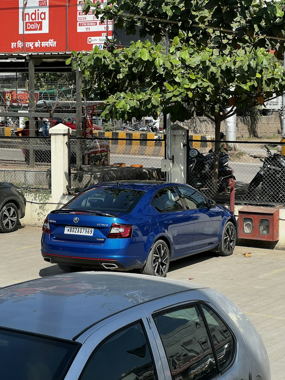 a blue car parked on the side of the road