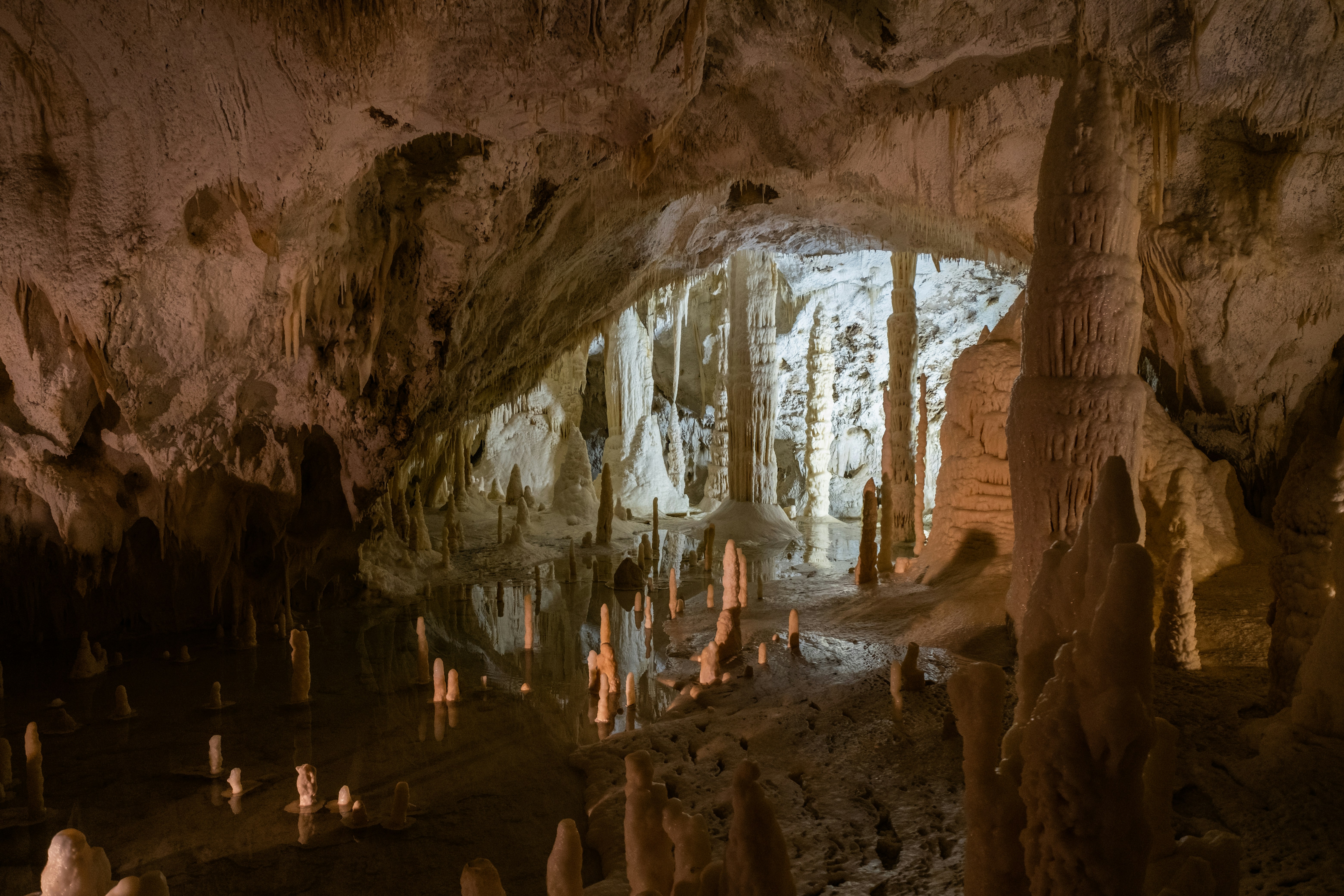 a group of people standing inside of a cave