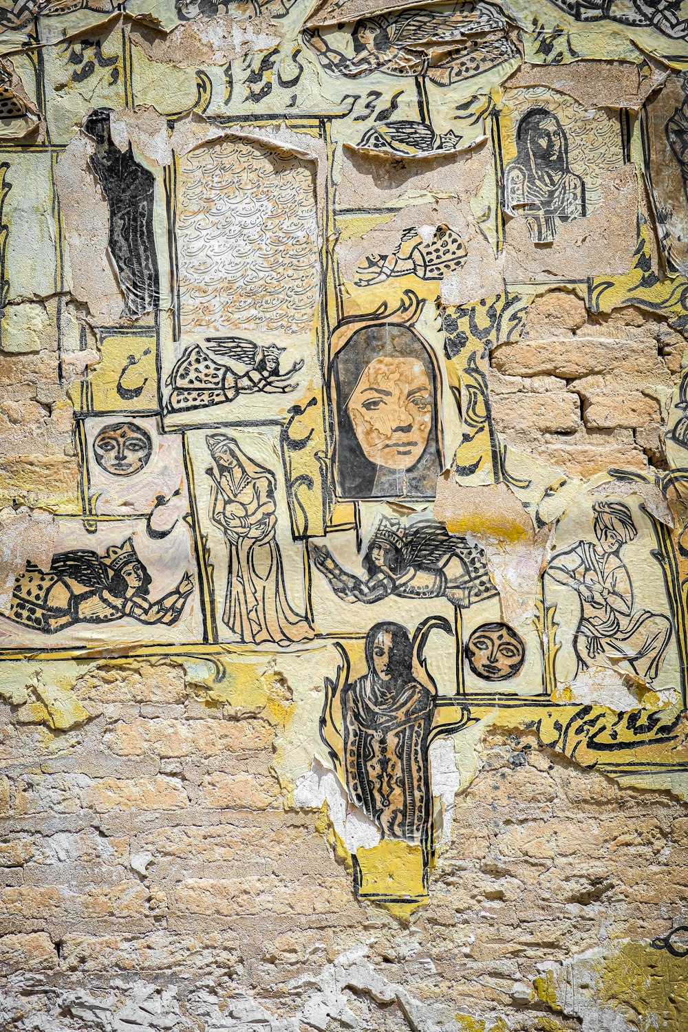 a painting on a stone wall with pictures of people and animals