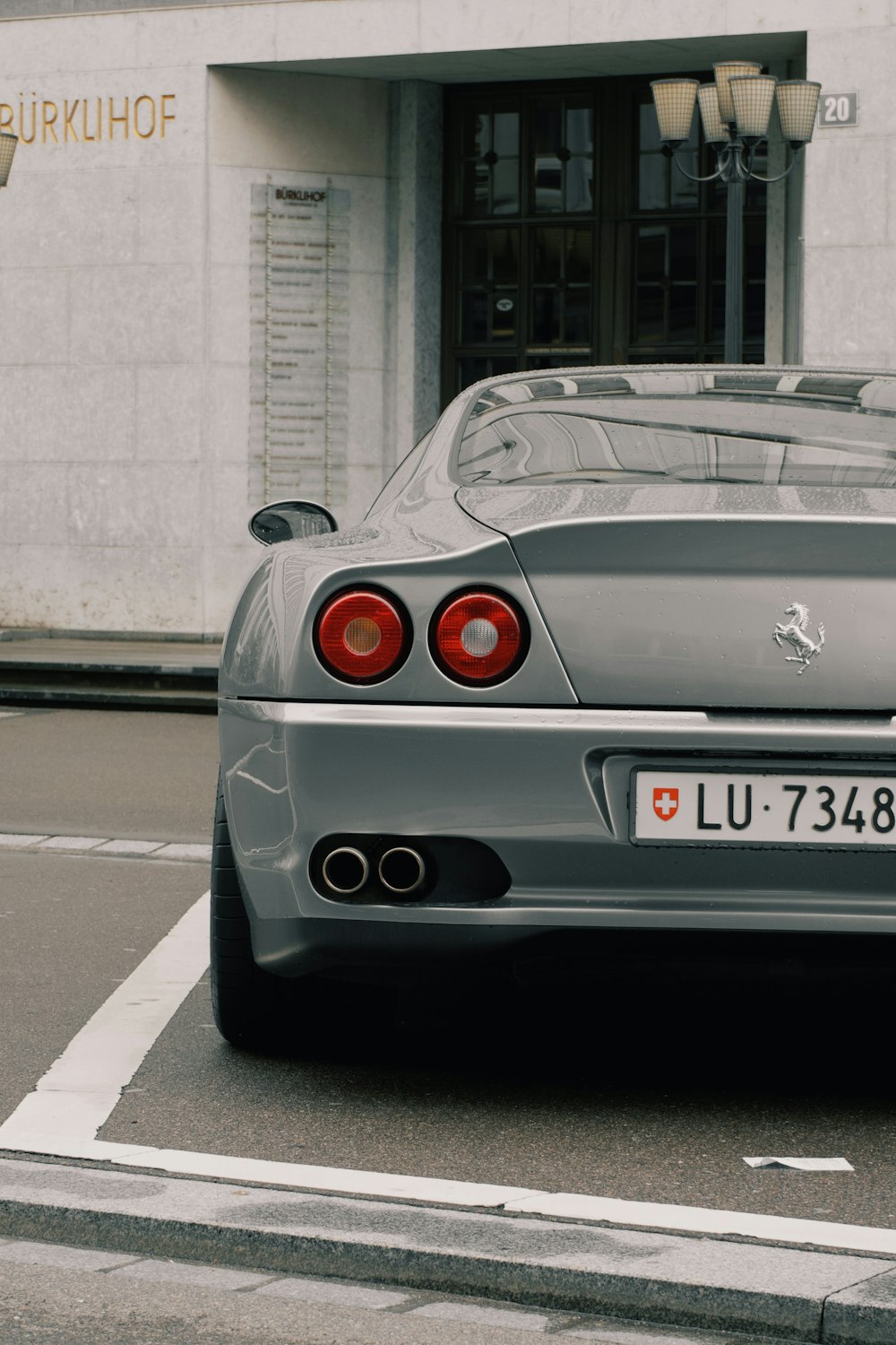 a silver sports car parked in front of a building