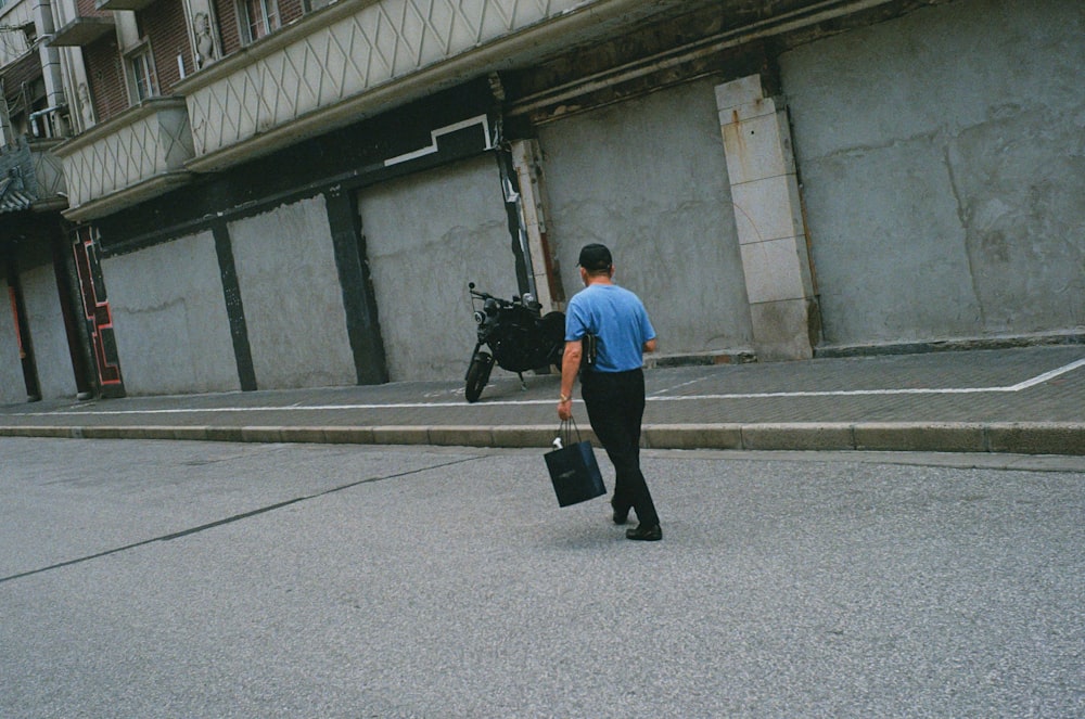 a man walking down a street carrying a briefcase