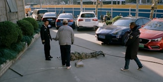 a group of men standing next to each other in a parking lot