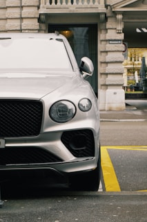 a silver car parked in front of a building