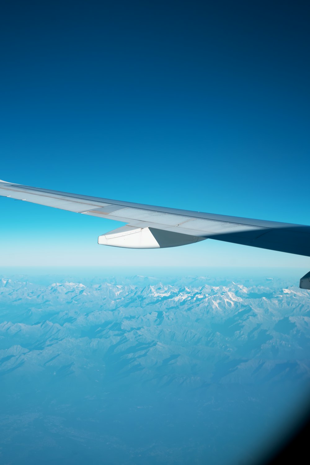 a view of the wing of an airplane in the sky