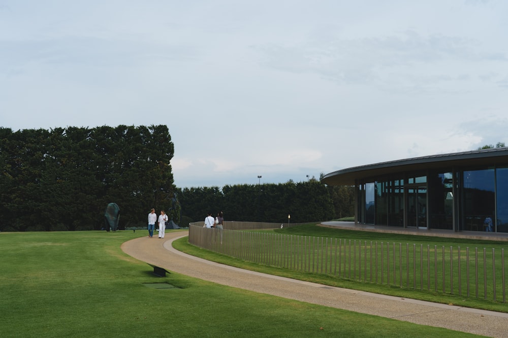 a group of people standing on top of a lush green field