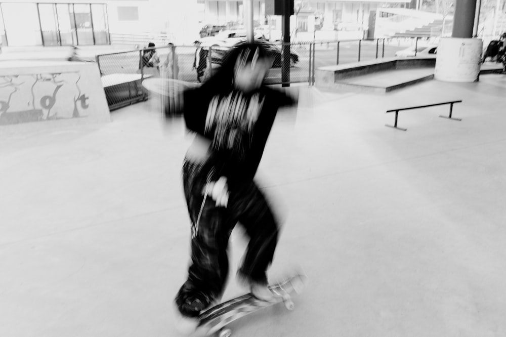 a black and white photo of a person on a skateboard
