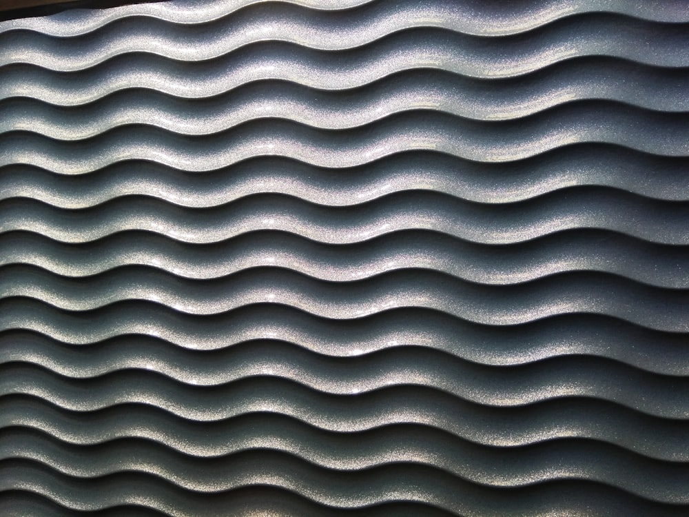 a close up of a wall with wavy lines