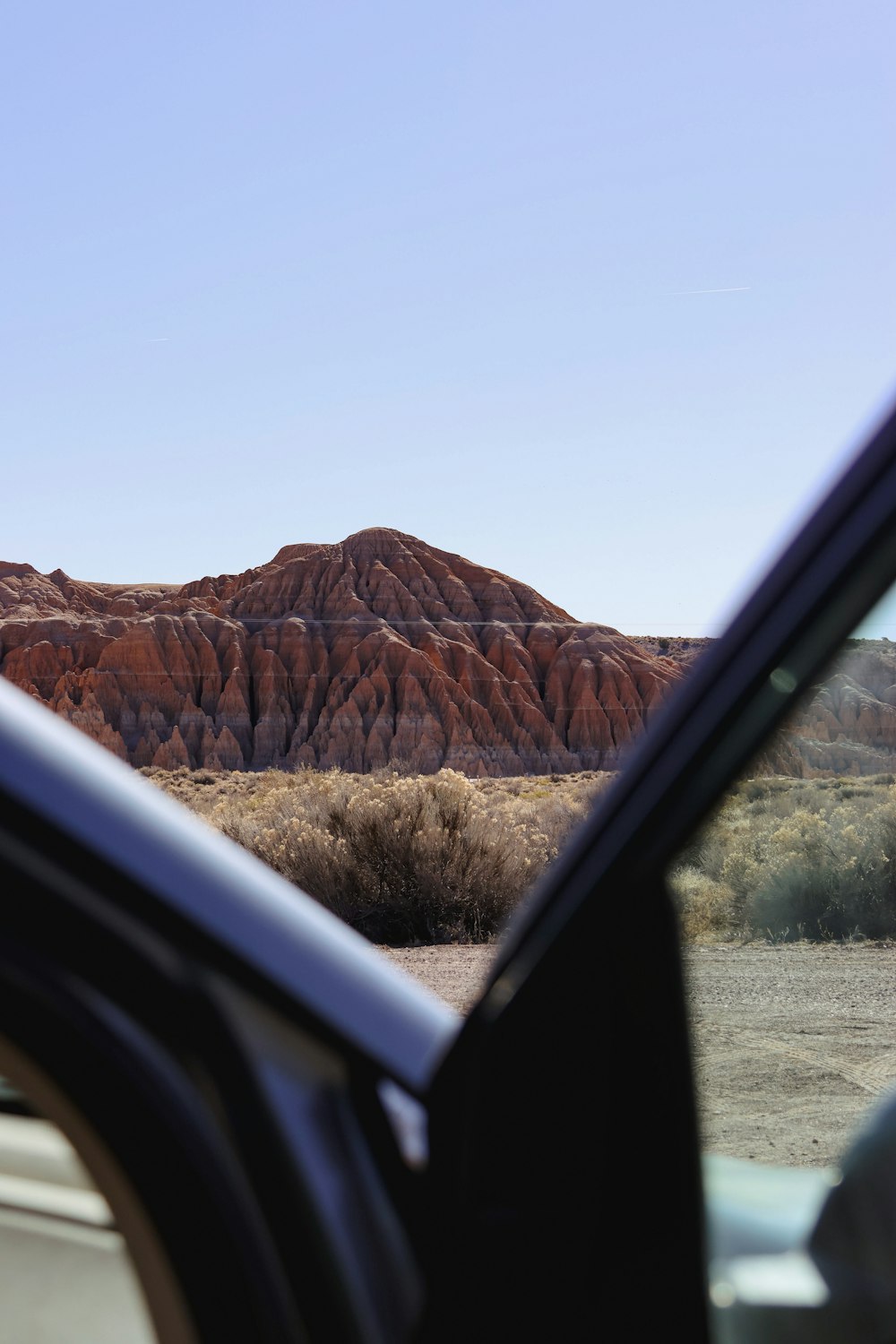 a car is parked in front of a mountain