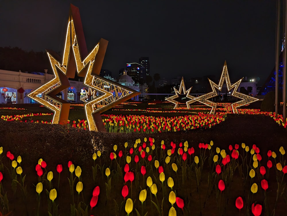 a field of tulips and other flowers lit up at night