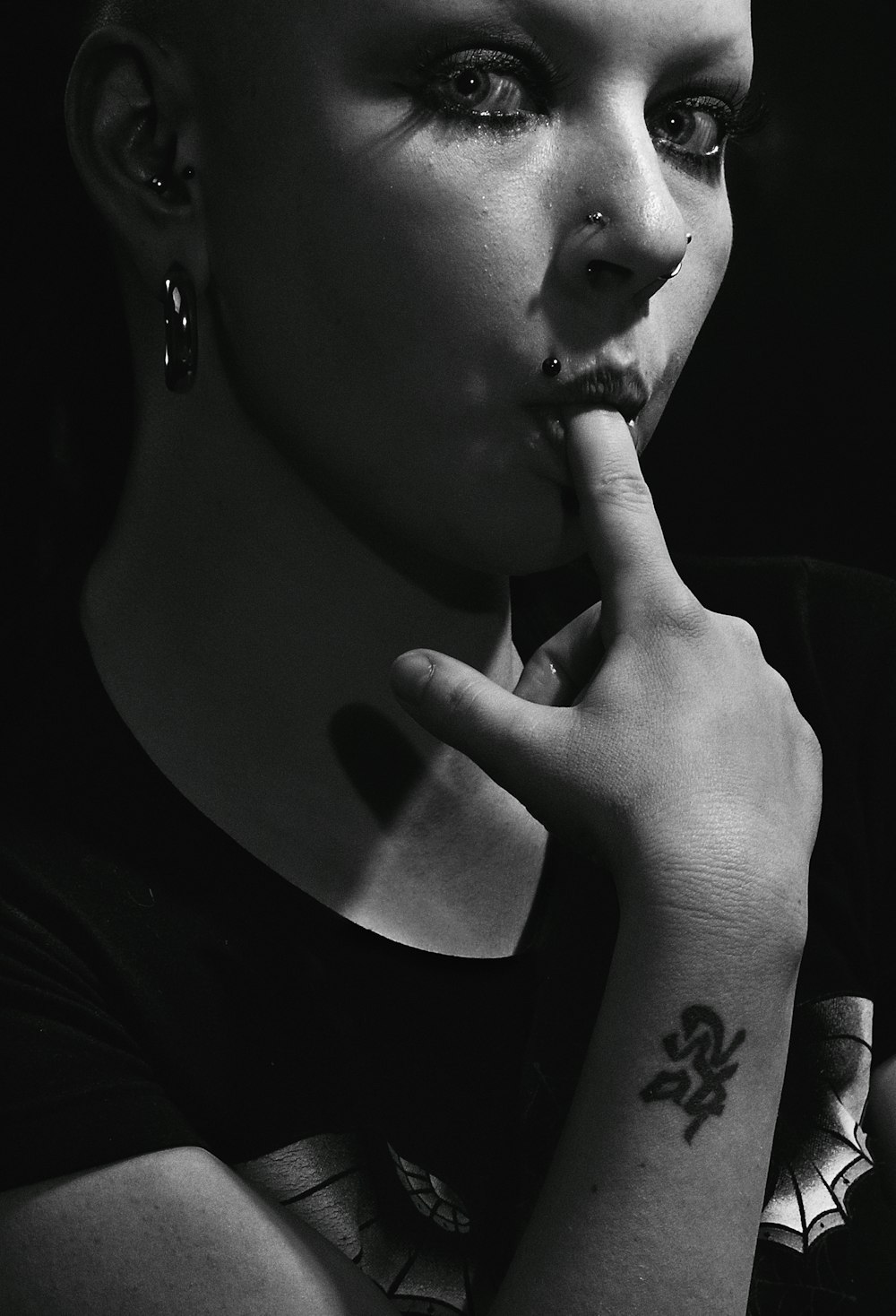 a black and white photo of a woman smoking a cigarette