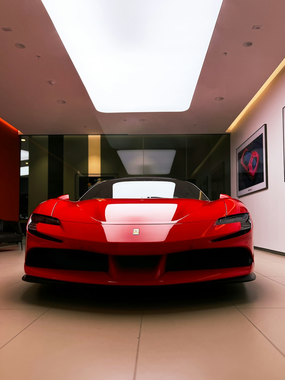 a red sports car is parked in a room